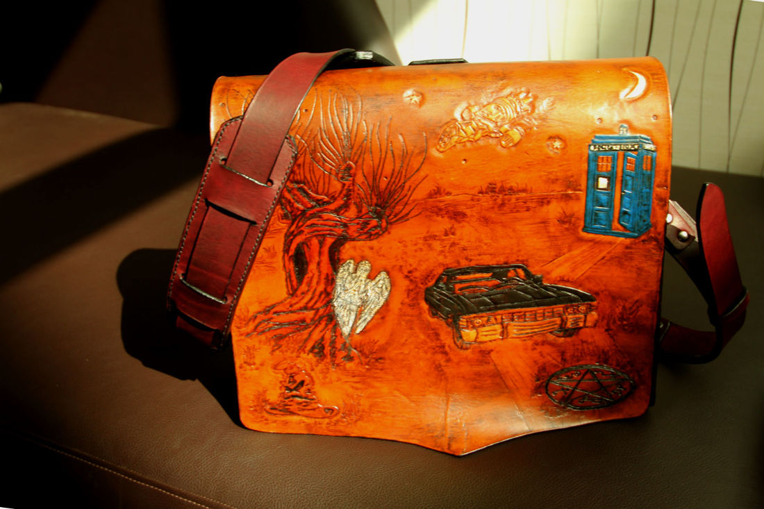 Custom Geek Messenger Bag with Firefly class spaceship, Serenity, The Winchester Brother's ride, Baby, a Weeping Angel hidding behind Hogwart's Womping Willow as well as Hogwart's Sorting Hat, and the always bigger on the inside, TARDIS. 