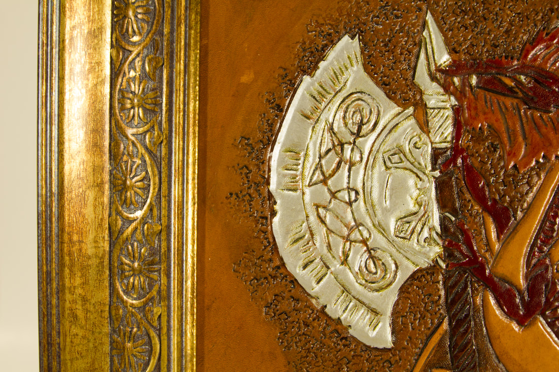Close-Up of the ax that dragon is holding and the brassy frame flowered vine design.