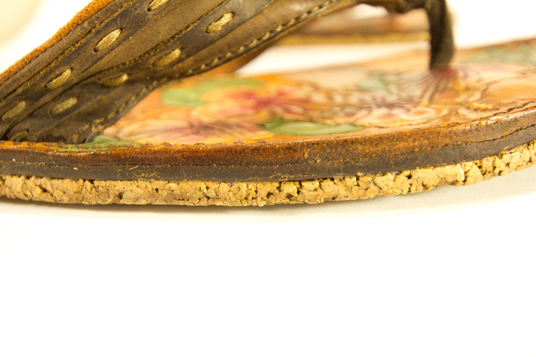 Close-Up of the side of the flip-flop showing the layer of cork, aka the sole of the flop.